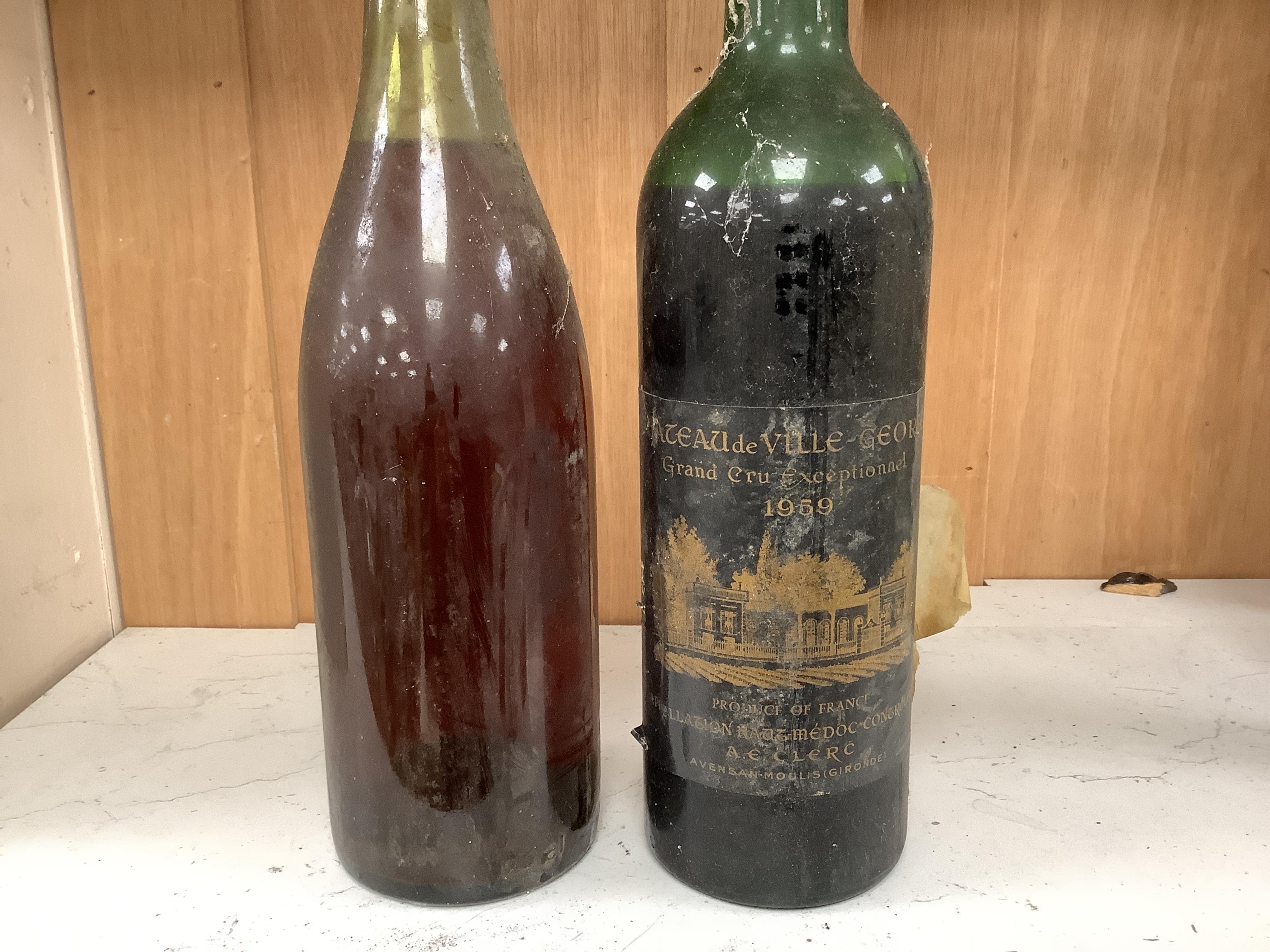 Fifteen bottles of wine and fortified wine, including; a Sandeman 1963 port, four bottles of Chateau La Rose Capbern 1953, a 1976 Madiran Cuvee de la Confrerie, etc. Condition - poor to fair, storage history unknown